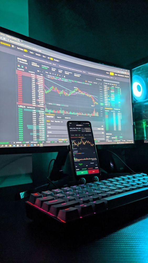 Stock market trading dashboard displayed on multiple monitors